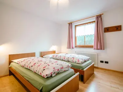 a bedroom with a bed and white cabinets at Apartment Trottner by Interhome in Mazzin