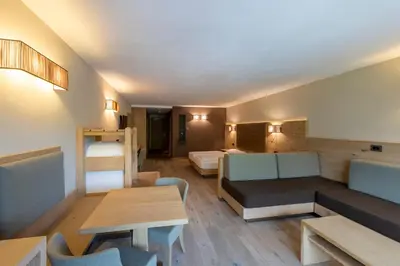 a living room with a couch and a table at Design & Suite Hotel Ciarnadoi in Vigo di Fassa
