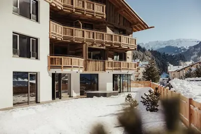 a hammock and an umbrella next to a pool at Luxury Chalet Milé in Ortisei