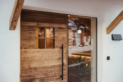 a room with two chairs and a table and a window at Luxury Chalet Milé in Ortisei