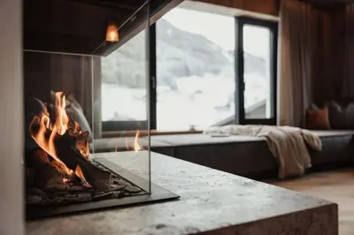 a living room with a couch and a fireplace at Luxury Chalet Milé in Ortisei