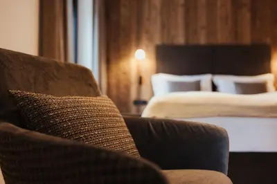 a bedroom with a large bed and a large window at Luxury Chalet Milé in Ortisei