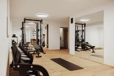 a woman holding a dumbbell in a gym at Luxury Chalet Milé in Ortisei