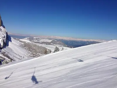 a shadow of a person skiing down a snow covered slope at Hotel Arnaria in Ortisei