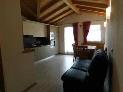 a living room with a table and a couch at Ciasa Weiss in Vigo di Fassa
