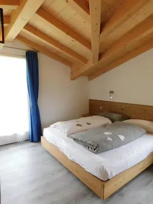 a living room with a black couch and a table at Ciasa Weiss in Vigo di Fassa