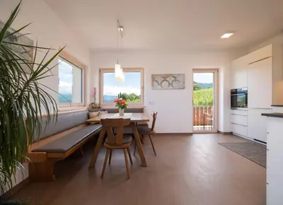 a kitchen and dining room with a table and chairs at Ferienwohnung Haas in Appiano sulla Strada del Vino