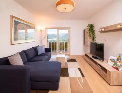 a white bedroom with a large bed with a window at Ferienwohnung Haas in Appiano sulla Strada del Vino