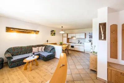 a living room with a couch and a kitchen at Unterpfaffstall-Hof in Collalbo