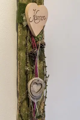 a heart hanging on a wall with a hat and rope at Unterpfaffstall-Hof in Collalbo
