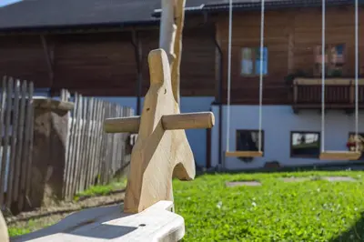 a wooden statue of a horse on a swing at Unterpfaffstall-Hof in Collalbo