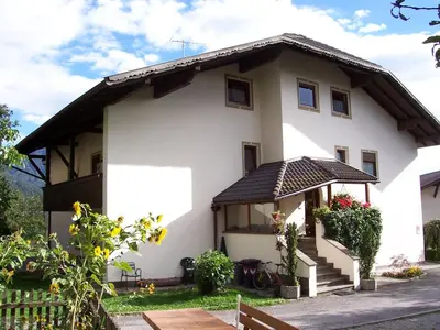 a white house with a brown roof at Mairhof in Laion