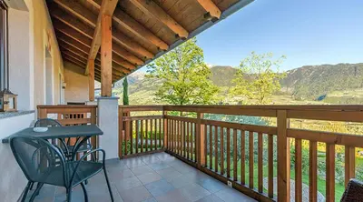 a porch with a table and chairs on a balcony at Villa Residence Franziskus in Tirolo