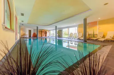 a swimming pool in the middle of a house at Villa Residence Franziskus in Tirolo