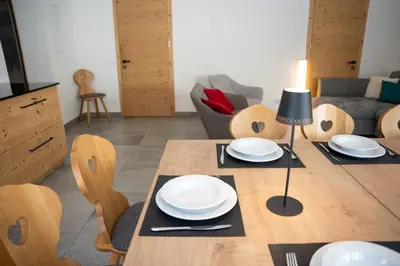 a dining room with a table with plates on it at Chalet Fisti in La Villa