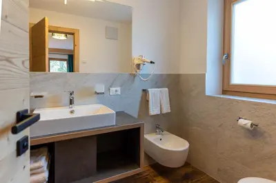 a bathroom with a sink and a toilet and a mirror at Chalet Fisti in La Villa