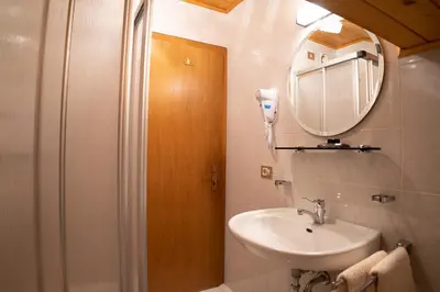 a bathroom with a sink and a mirror at Chalet Fisti in La Villa