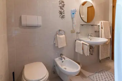 a bathroom with a toilet and a sink at Chalet Fisti in La Villa