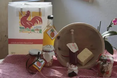 a table topped with a table with a chicken and a bag at Le Maier in San Vigilio Di Marebbe