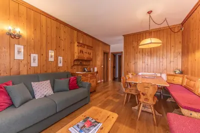 a living room with a couch and a table at Ca' Milijera in Cortina dʼAmpezzo