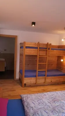 a bedroom with two bunk beds in a room at Apartments Salieta in Santa Cristina in Val Gardena