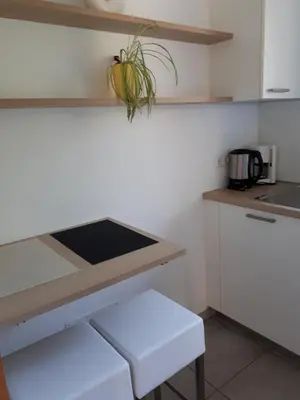 a kitchen with white cabinets and a counter top at Urbanhof Prantenberger in Bolzano