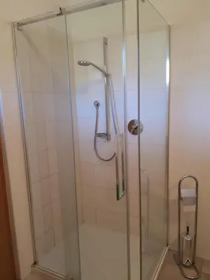 a shower with a glass door in a bathroom at Urbanhof Prantenberger in Bolzano