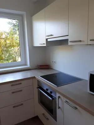 a kitchen with a stove top oven next to a window at Urbanhof Prantenberger in Bolzano