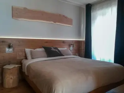 a bedroom with a large bed and a window at Ciasa David Marebbe in San Vigilio Di Marebbe