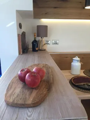 a heart shaped bowl of apples on a wooden table at Ciasa David Marebbe in San Vigilio Di Marebbe