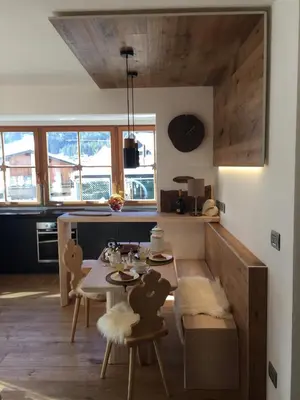 a kitchen with a table and chairs in a room at Ciasa David Marebbe in San Vigilio Di Marebbe