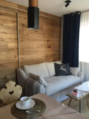 a living room with a couch and a table at Ciasa David Marebbe in San Vigilio Di Marebbe