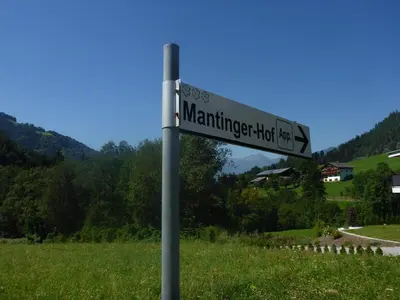 a street sign on a pole in a field at Apartments Dolomites 