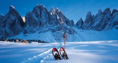 a pair of skis in the snow in front of a mountain at Apartments Dolomites 