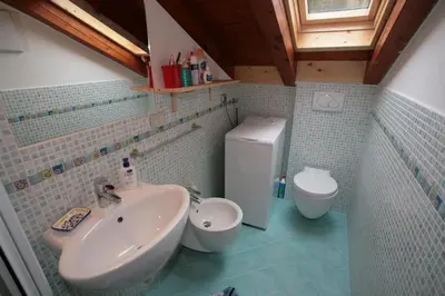 a bathroom with a sink and a toilet at Residence Anny in Canazei