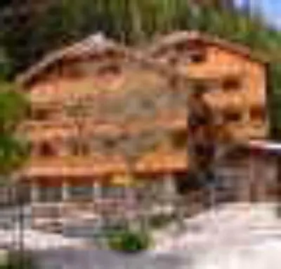 a large house with a large building at Residence Anny in Canazei
