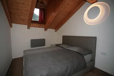 a bedroom with a large bed and a window at Residence Anny in Canazei