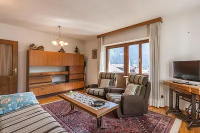 a living room with two couches and a tv at Casa Elena in Canale dʼAgordo