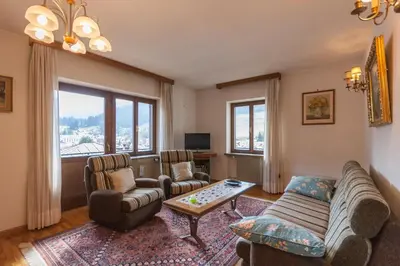 a living room with a couch and chairs and a table at Casa Elena in Canale dʼAgordo