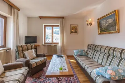 a living room with a couch and a coffee table at Casa Elena in Canale dʼAgordo