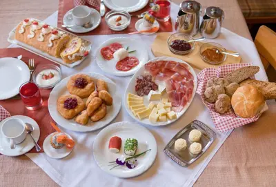 a table with many plates of food on it at Gönnerhof in Perca