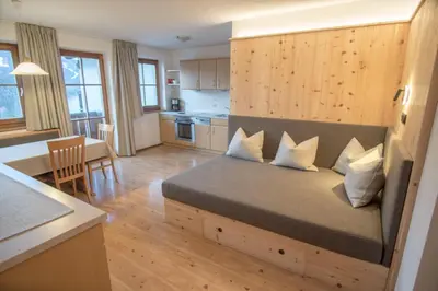 a bedroom with a bed and a kitchen with a table at Gönnerhof in Perca