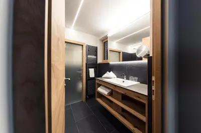 a bathroom with a sink and a mirror at Weingut Moser Apartments in Caldaro