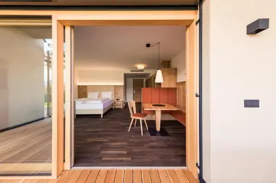a room with a sliding door leading to a bedroom at Weingut Moser Apartments in Caldaro