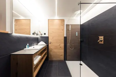 a bathroom with a sink and a shower at Weingut Moser Apartments in Caldaro