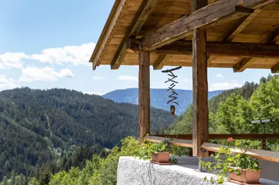 a view of the mountains from the porch of a house at Spitalerhof Apartment & Sauna in Verano