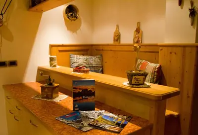 a room with a table with a book on it at Hotel Garni Ongaro in Selva di Cadore