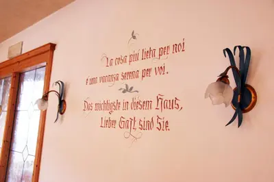 a wall with a writing on it with lights on it at Hotel Garni Ongaro in Selva di Cadore