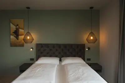 a bedroom with a bed and a nightstand next to a bed sidx sidx sidx at Haus Artus in Schenna