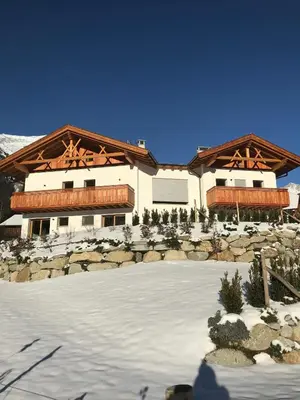 a large building with snow in front of it at Oberkircher in Fundres